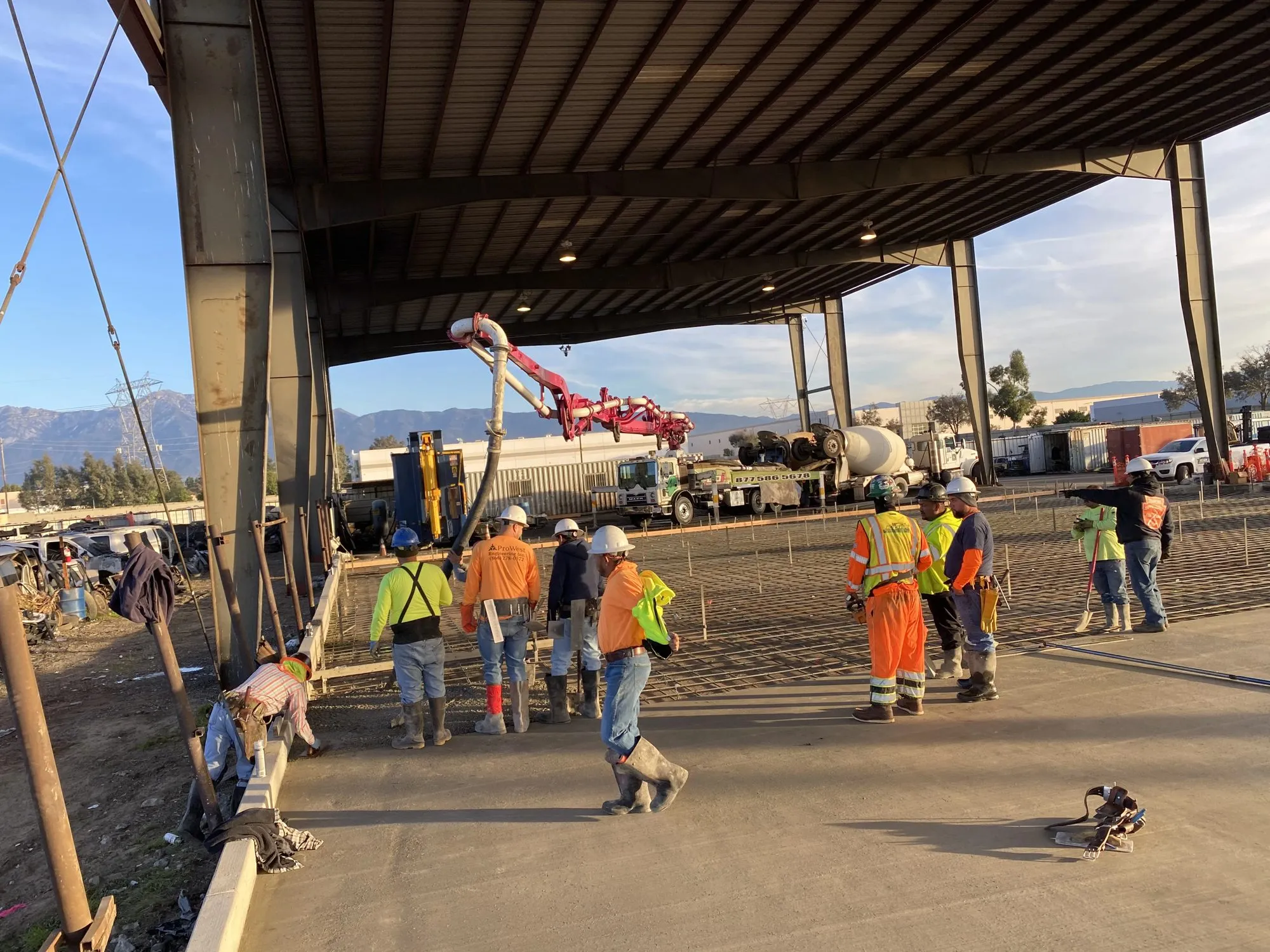 Crew pouring a large commercial concrete foundation